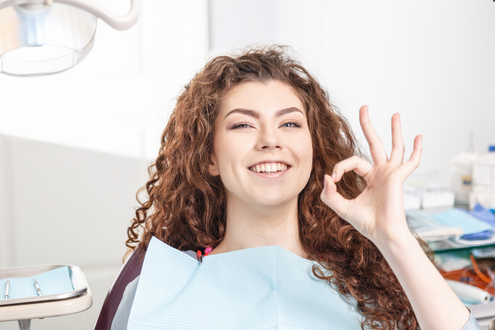 Happy woman smiling while on a dental appointment - Veneers in Lynnwood WA Happy woman smiling while on a dental appointment - Veneers in Lynnwood WA