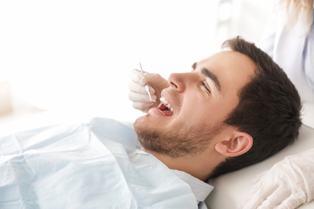 Man having a dental procedure - veneers Man having a dental procedure - veneers