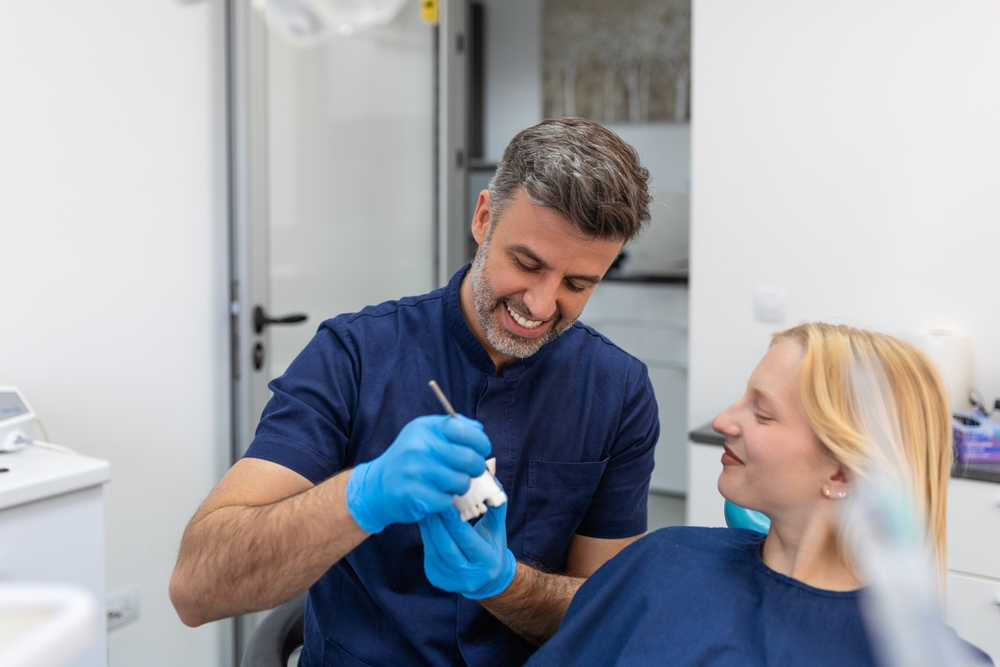 Dentist explaining a dental procedure to a patient - Dental Crowns Dentist explaining a dental procedure to a patient - Dental Crowns
