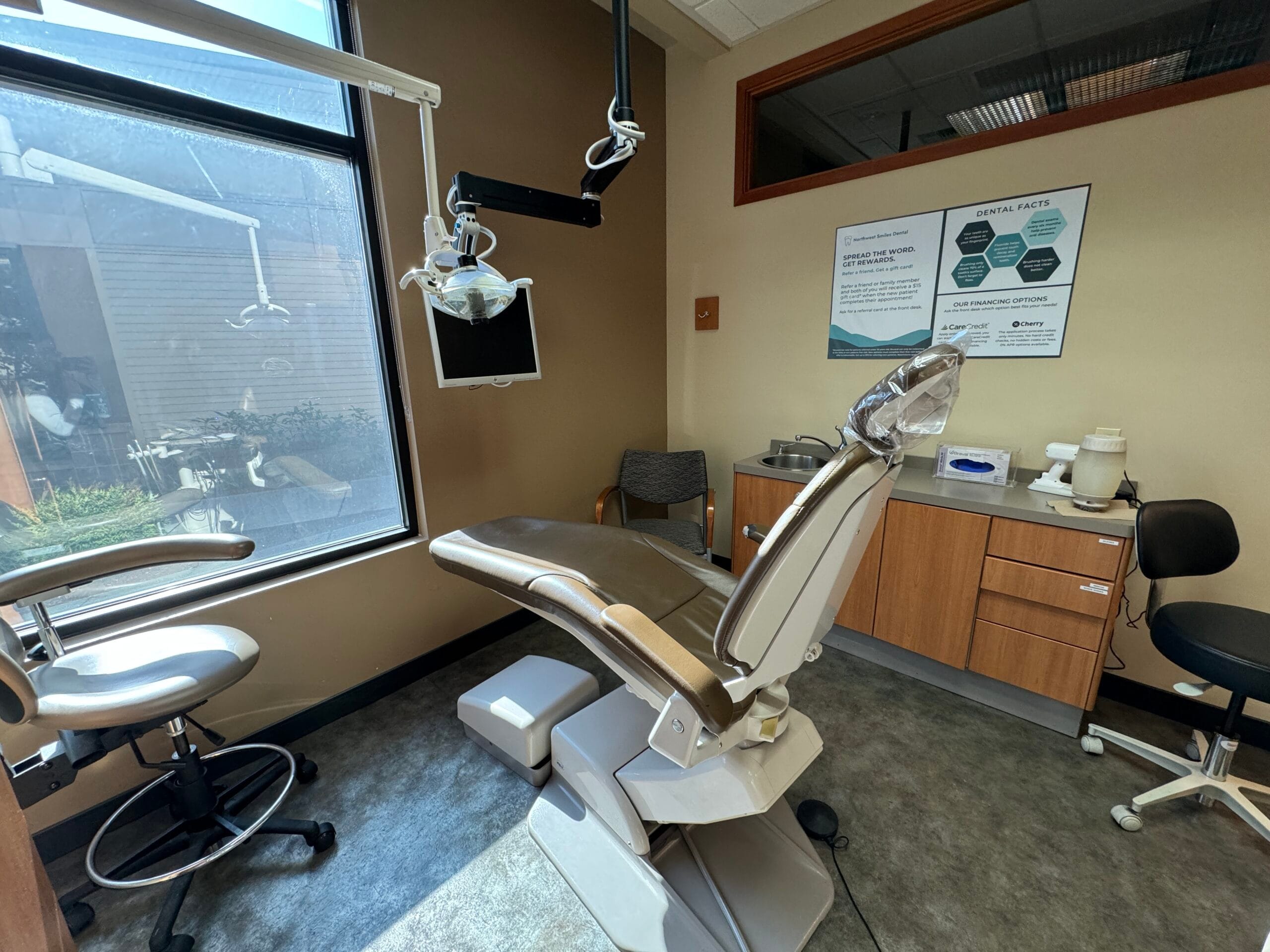 Teenage girl holding a teeth model and a toothbrush - Dentist in Bonney Lake WA