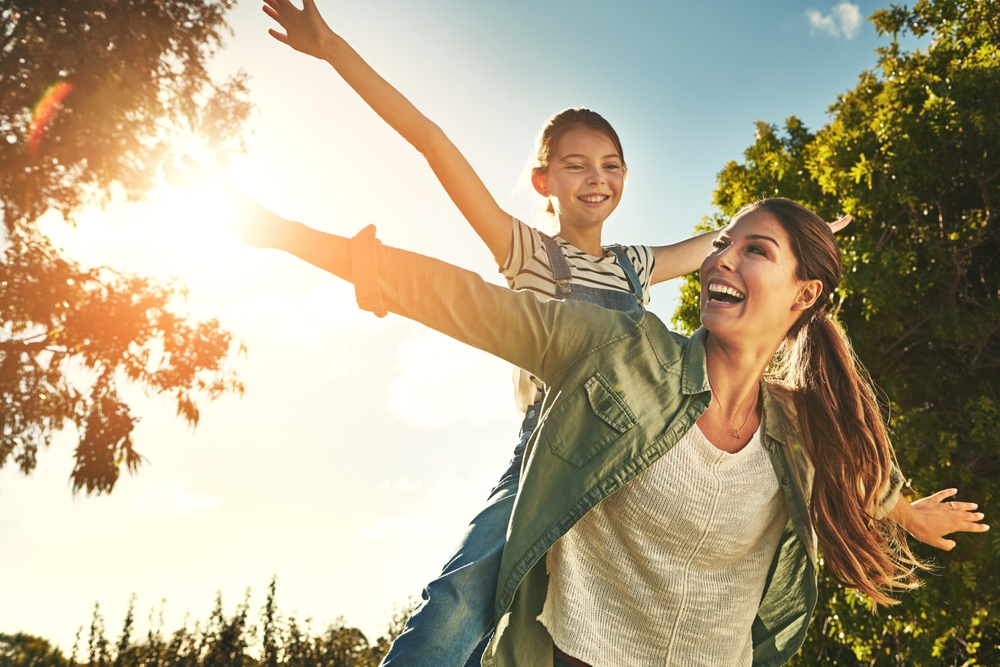 Mother and daughter playing outdoors - Dentist in Federal Way WA