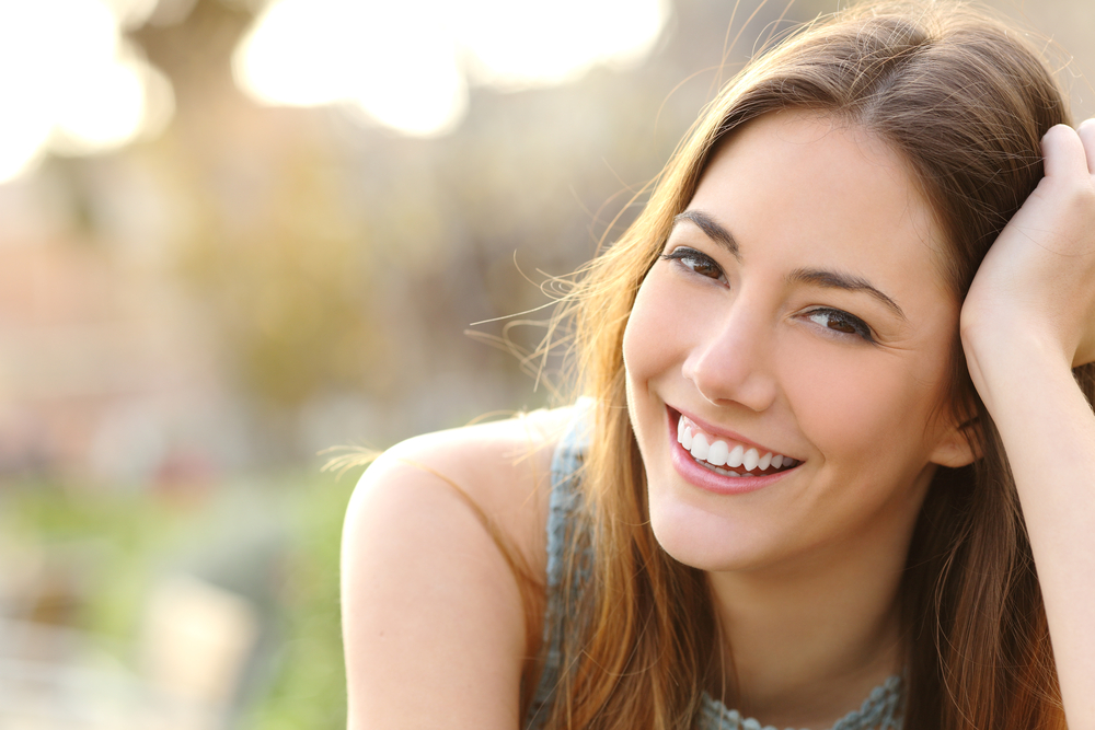 Happy woman outdoors - Teeth Cleaning in Lynnwood Happy woman outdoors - Teeth Cleaning in Lynnwood