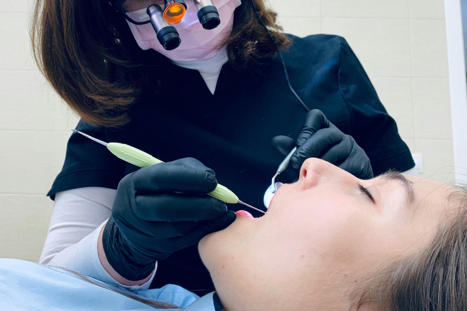 Scaling and root planing on a patient.