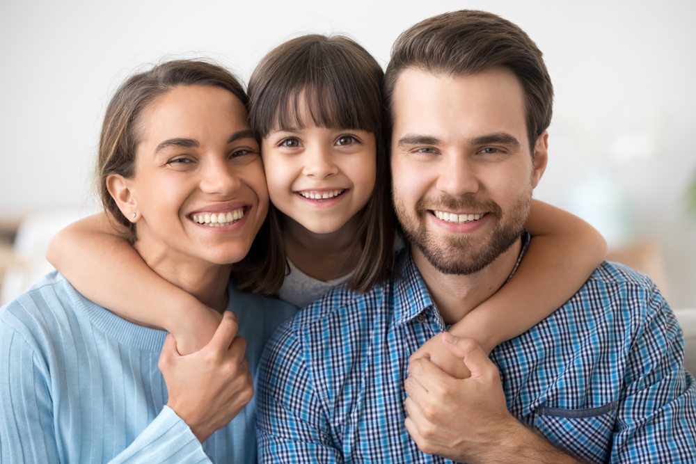 Happy family smiling for a portrait - Dental Bonding Happy family smiling for a portrait - Dental Bonding