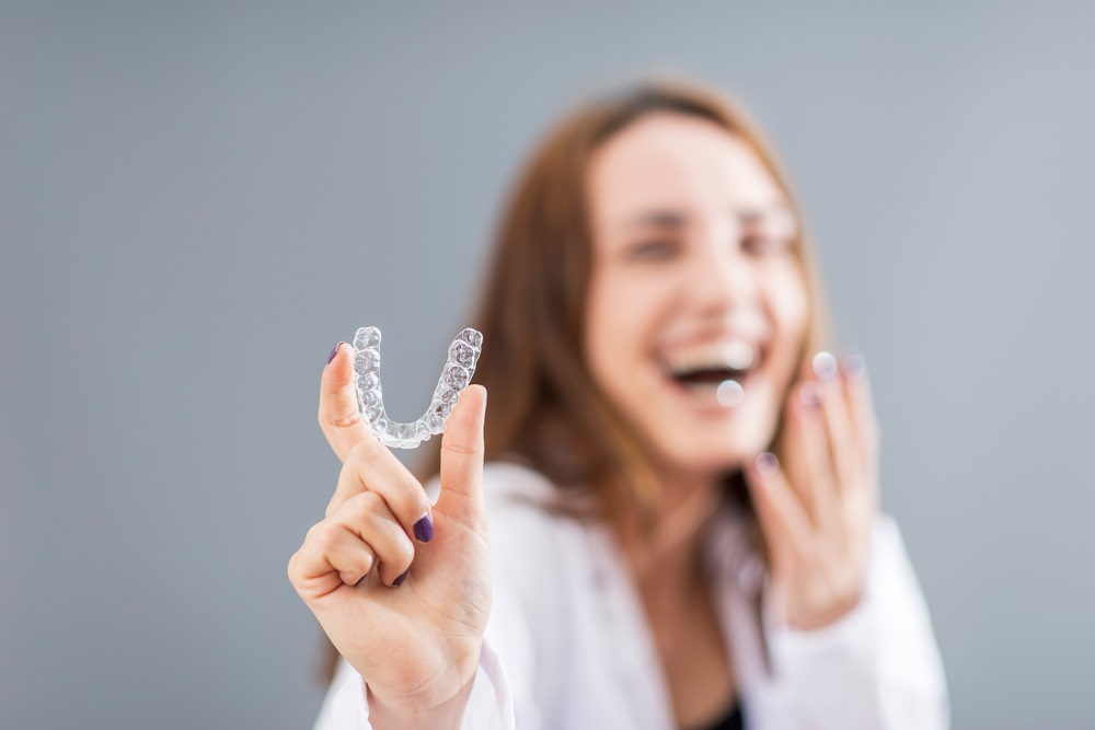 Woman holding an invisalign - Veneers in Federal Way