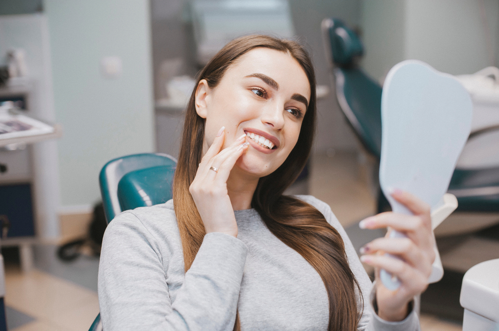 Female patient looking at her teeth - Dentist in Federal Way WA
